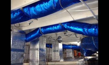 Inside new build with blue exposed duct work