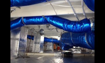 Inside new build with blue exposed duct work