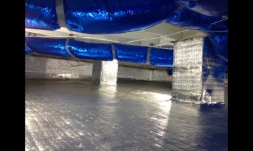 Inside new build with blue exposed duct work