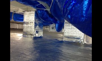 Inside new build with blue exposed duct work