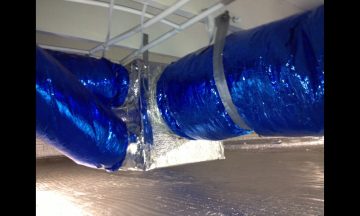 Inside new build with blue exposed duct work