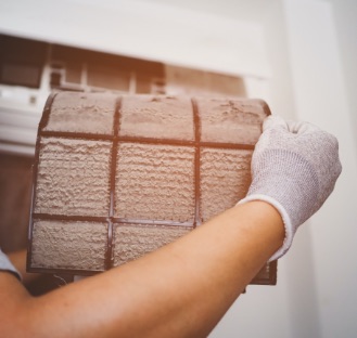 persons hand cleaning out a duct